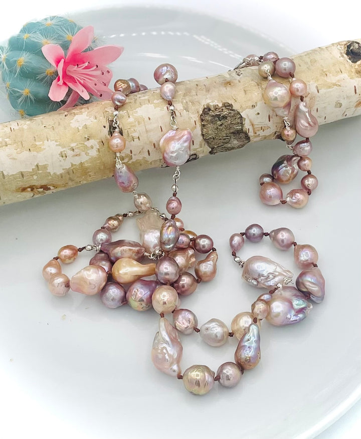 Silk knotted and wire wrapped long treasure necklace featuring natural luster, baroque, Flameball, and Edison pearls with sterling silver accents. Available only from Rockstar Cowgirl online or in store in Cody, Wyoming.