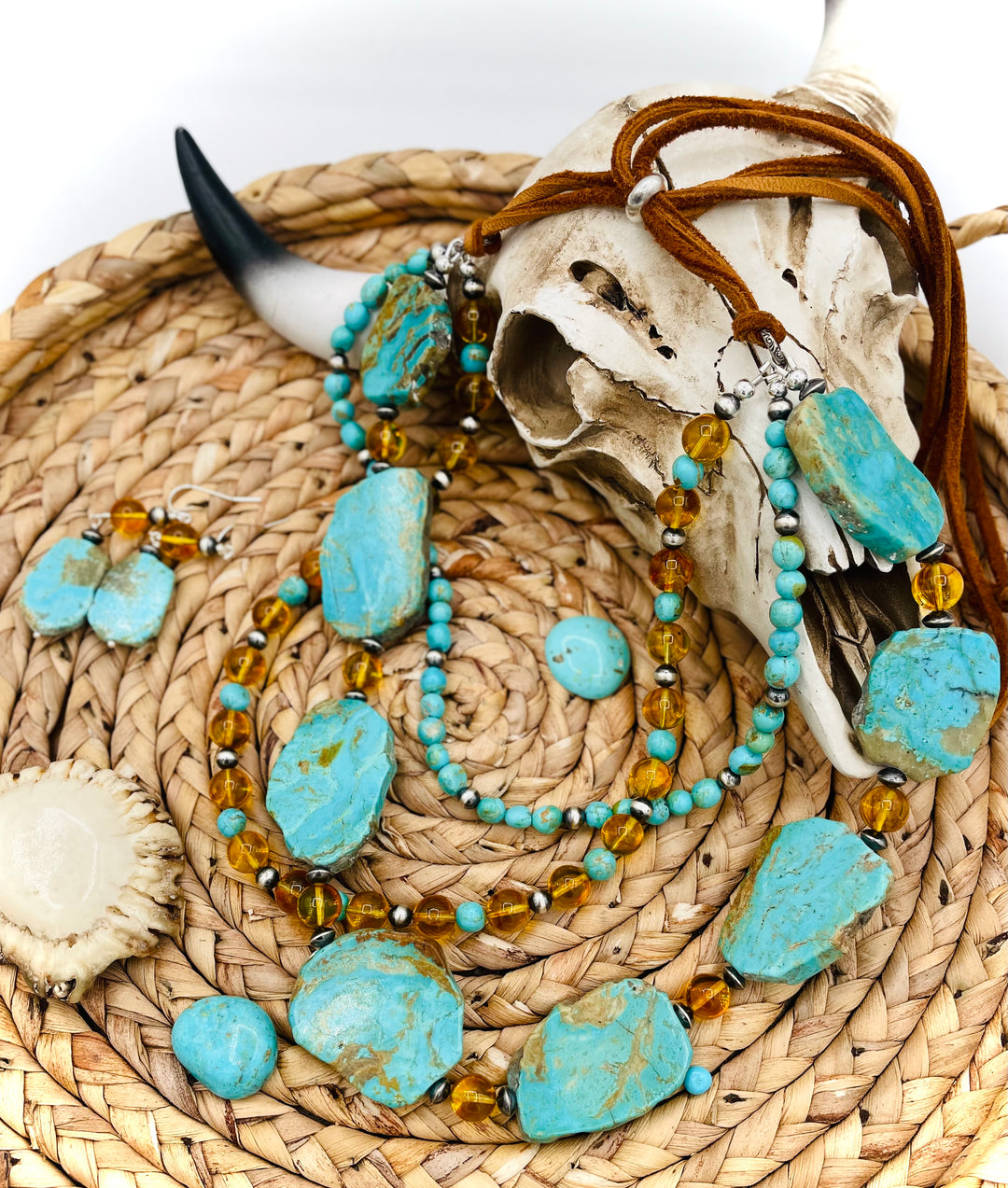 Beaded three strand necklace featuring Kingman turquoise, Baltic amber, sterling silver beads, and finished with deer lace and slide bead. Includes matching earrings. Available only from Rockstar Cowgirl online or in store in Cody, Wyoming.
