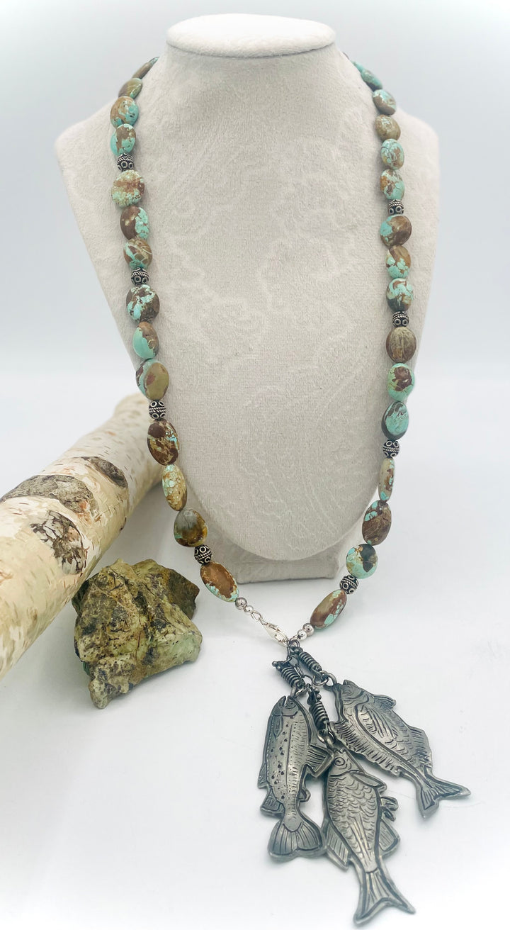Beaded necklace featuring vintage #8 turquoise nuggets, sterling silver beads, and handmade sterling silver signed fish charms. Marcie. Available only from Rockstar Cowgirl online or in store in Cody, Wyoming.