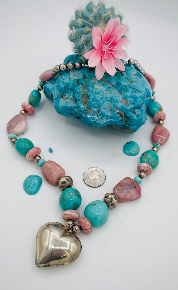 Chunky beaded necklace featuring Pink opal nuggets, rhodochrosite, sterling silver beads, Kingman turquoise nuggets, and sterling silver puffy heart pendent. U.S. quarter for size reference. Available only from Rockstar Cowgirl online or in store in Cody, Wyoming.
