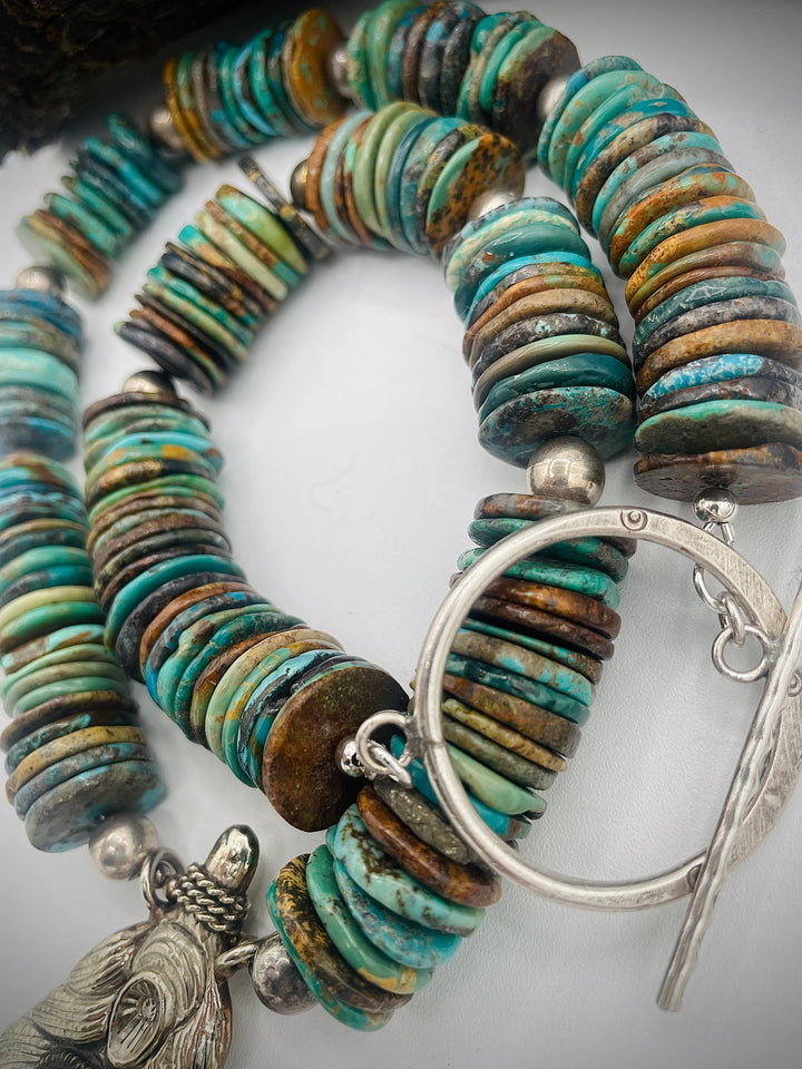 Handmade beaded necklace featuring turquoise discs, sterling silver beads, and Tibetan silver pendent with turquoise inlays. Available only from Rockstar Cowgirl online or in store in Cody, Wyoming.