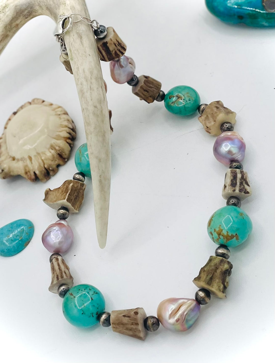 Handmade beaded necklace featuring Kingman turquoise nuggets, deer antler beads, natural luster baroque pearls, and sterling silver beads. Available only from Rockstar Cowgirl online or in store in Cody, Wyoming.