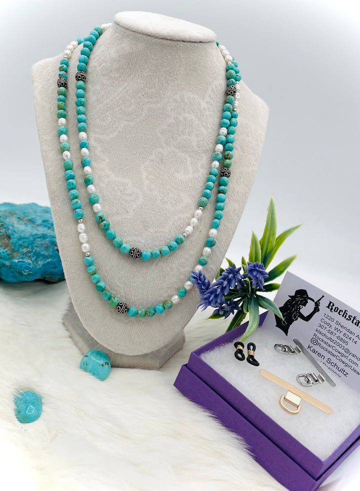 Beaded invention necklace featuring Kingman turquoise, freshwater pearls, sterling sliver accent beads, with sterling silver swivel lobsters, eye glasses loops, and cell phone case attachment bracket. Available only from Rockstar Cowgirl online or in store in Cody, Wyoming. 