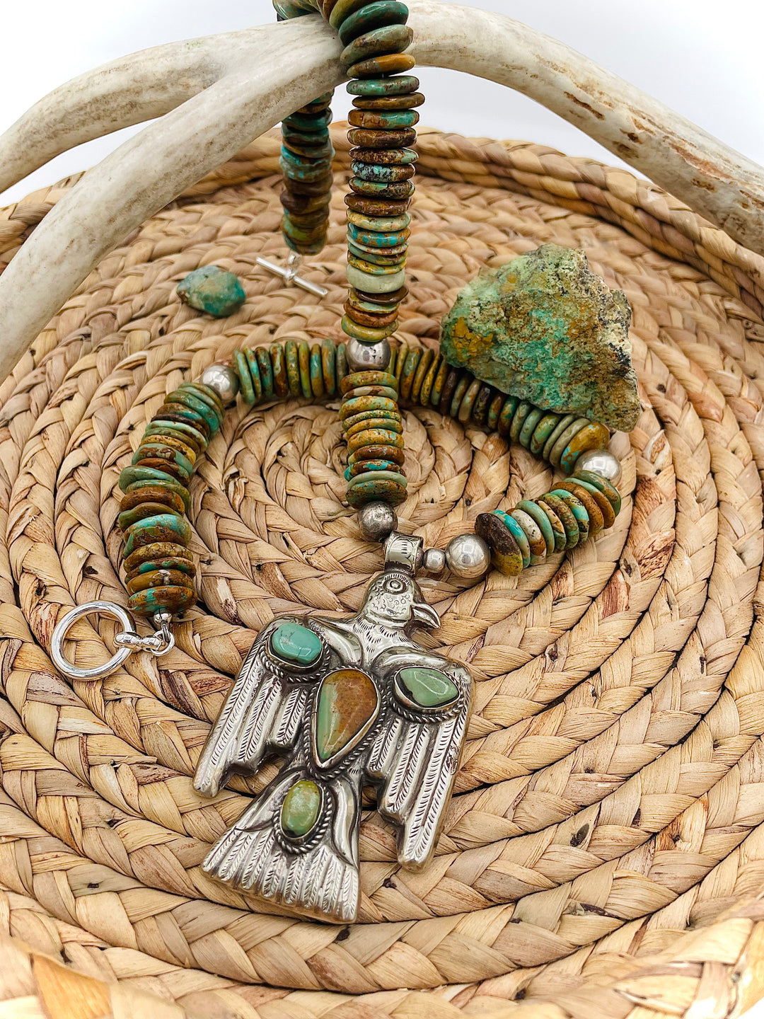 Handmade turquoise necklace featuring  turquoise discs, sterling silver accents, and Tibetan silver pendent. Available only from Rockstar Cowgirl online or in store in Cody, Wyoming.