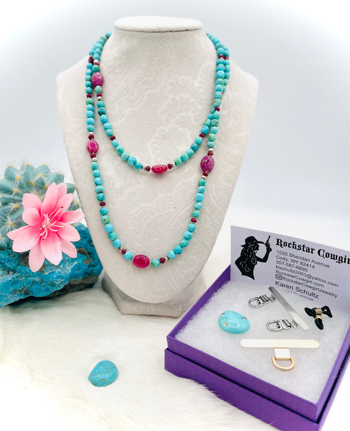 Beaded necklace, phone holder strap, or eye glass holder featuring blue Kingman turquoise, pink ruby nuggets and rondelles, sterling silver and African silver beads, sterling silver swivel lobsters, phone case attachments,  and glasses loops. Available only from Rockstar Cowgirl online or in store in Cody, Wyoming.
