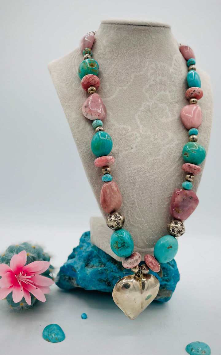 Chunky beaded necklace featuring Pink opal nuggets, rhodochrosite, sterling silver beads, Kingman turquoise nuggets, and sterling silver puffy heart pendent. Available only from Rockstar Cowgirl online or in store in Cody, Wyoming.