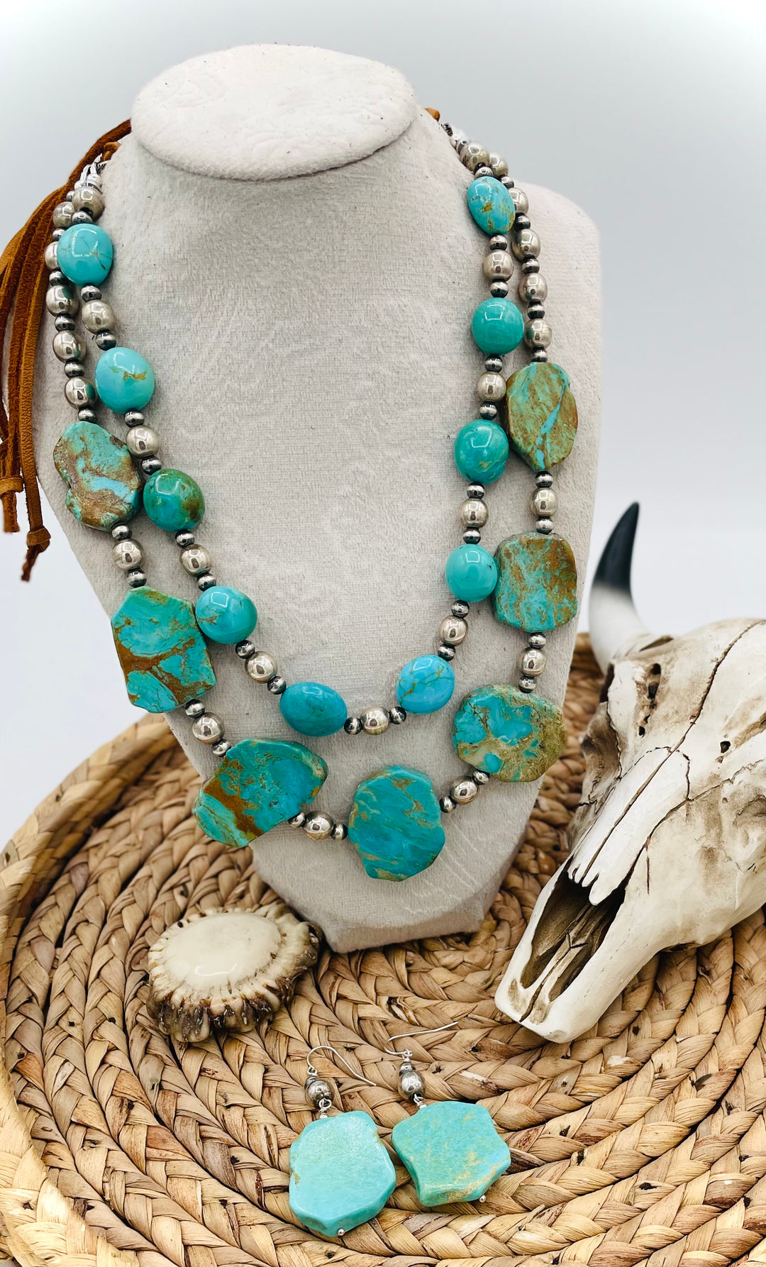 Beaded two strand necklace featuring Kingman turquoise and sterling silver beads and finished with  deer lace and slide bead. Including matching earrings. Available only from Rockstar Cowgirl online or in store in Cody, Wyoming.