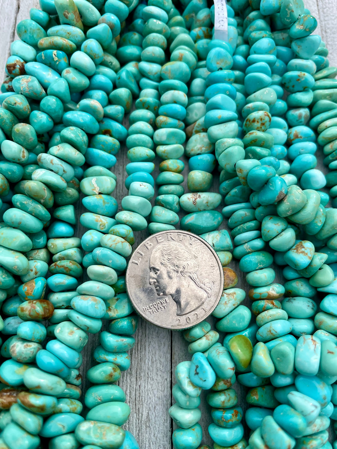 Blue Green center drilled nugget strands sold individually. U. S. quarter for size reference. Available only from Rockstar Cowgirl online or in store in Cody, Wyoming.