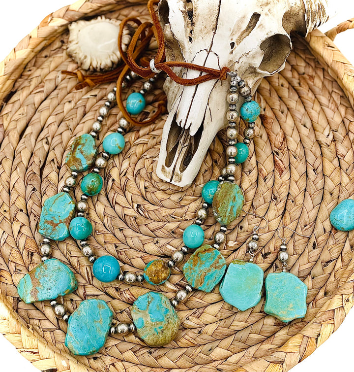 Beaded two strand necklace featuring Kingman turquoise and sterling silver beads and finished with  deer lace and slide bead. Including matching earrings. Available only from Rockstar Cowgirl online or in store in Cody, Wyoming.