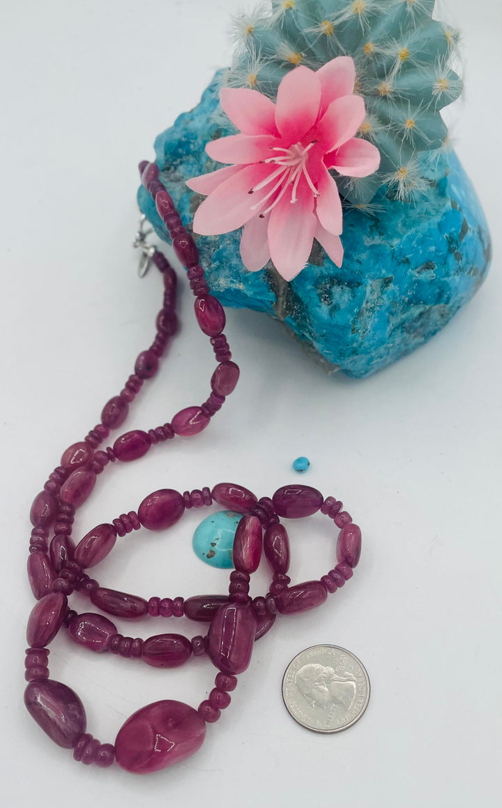 Long beaded necklace featuring natura ruby nuggets and rondelles. U.S. quarter for size reference. Available only from Rockstar Cowgirl online or in store in Cody, Wy.