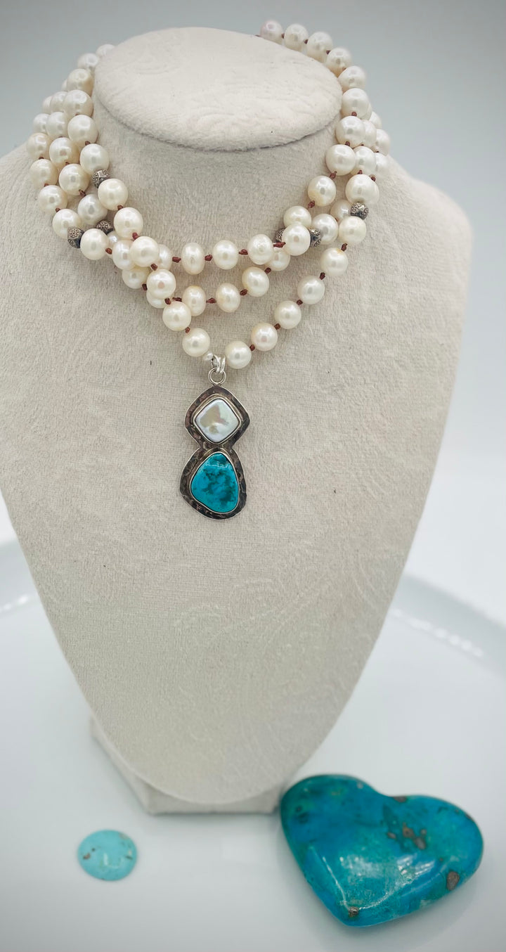 Silk knotted long necklace featuring white pearls, and sterling silver beads with a pearl and turquoise sterling silver pendent. Available only from Rockstar Cowgirl online or in store in Cody, Wyoming.