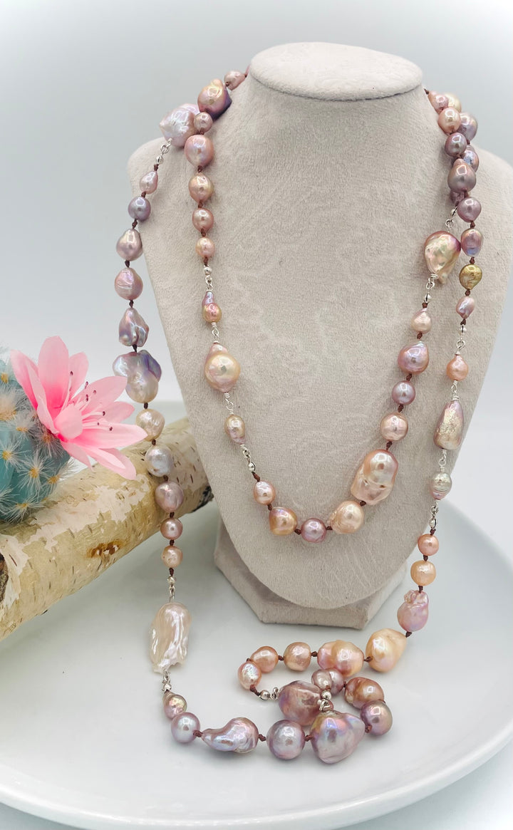 Silk knotted and wire wrapped long treasure necklace featuring natural luster, baroque, Flameball, and Edison pearls with sterling silver accents. Available only from Rockstar Cowgirl online or in store in Cody, Wyoming.