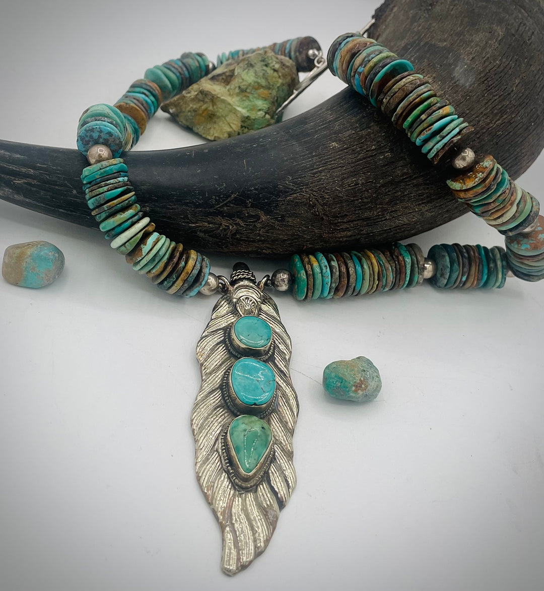 Handmade beaded necklace featuring turquoise discs, sterling silver beads, and Tibetan silver pendent with turquoise inlays. Available only from Rockstar Cowgirl online or in store in Cody, Wyoming.