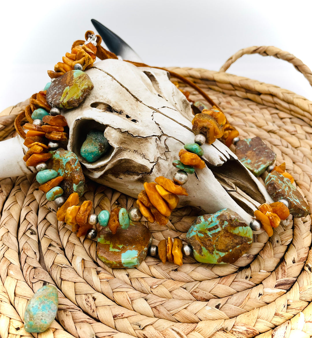 Beaded three strand necklace featuring Kingman turquoise, butterscotch amber, sterling silver beads, deer lace, and slide bead. Includes matching earrings. Available only from Rockstar Cowgirl online or in store in Cody, Wyoming.