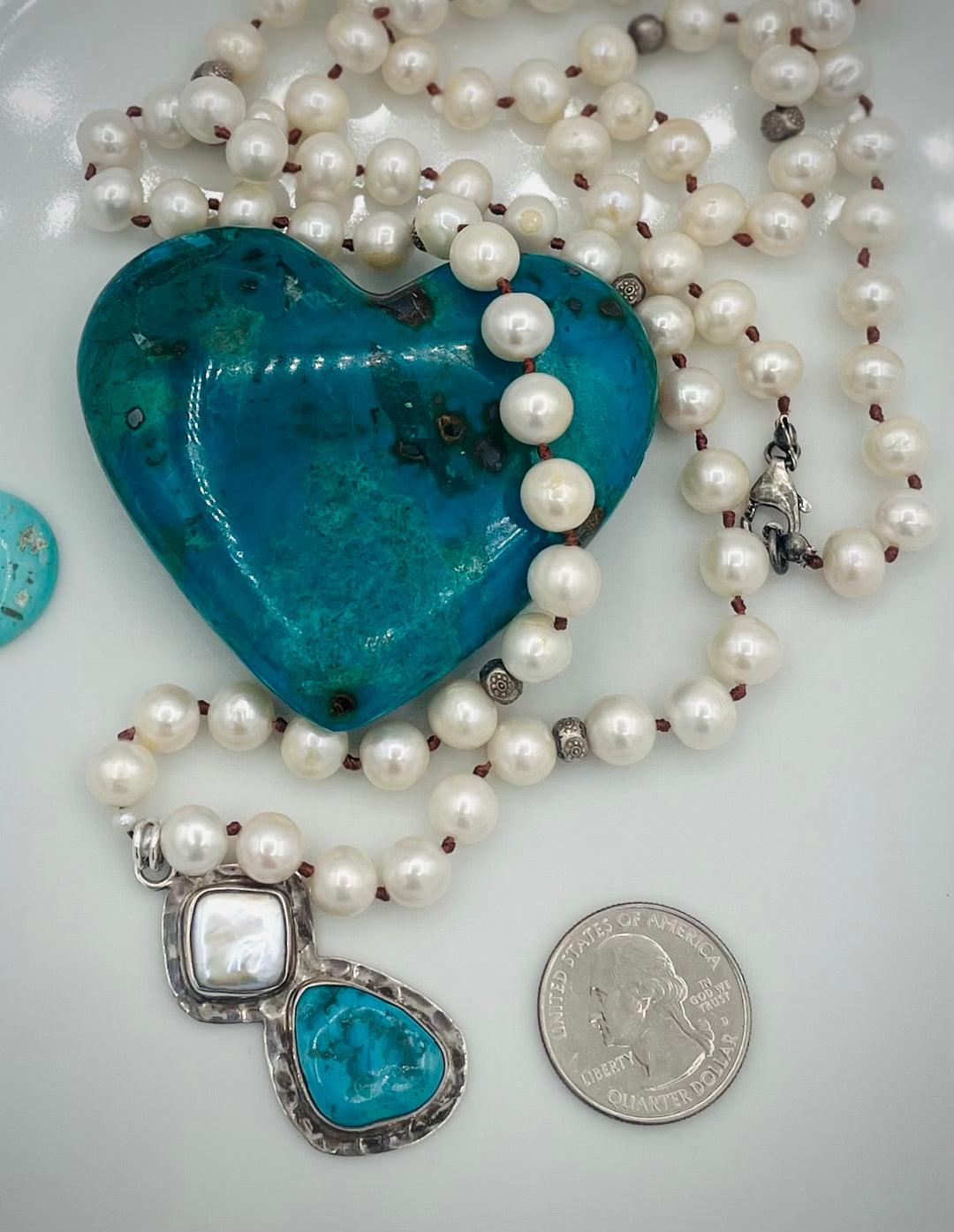 Silk knotted long necklace featuring white pearls, and sterling silver beads with a pearl and turquoise sterling silver pendent. U.S. quarter for size reference. Available only from Rockstar Cowgirl online or in store in Cody, Wyoming.