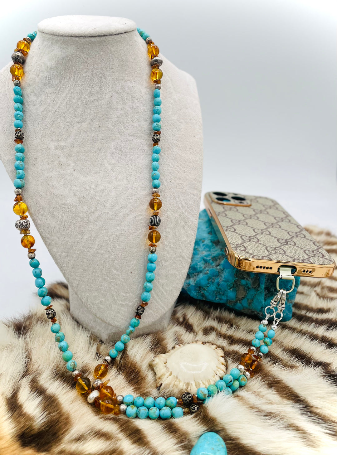 Beaded invention necklace featuring Kingman turquoise, Baltic amber, citrine, sterling silver and African silver accents with sterling silver swivel lobsters, eye glasses loops, cell phone case attachment bracket. Available only from Rockstar Cowgirl online or in store in Cody, Wyoming.