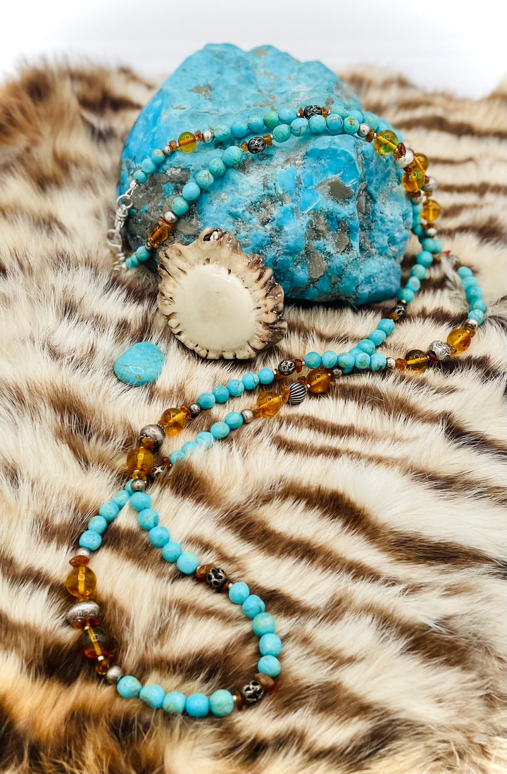Beaded invention necklace featuring Kingman turquoise, Baltic amber, citrine, sterling silver and African silver accents with sterling silver swivel lobsters, eye glasses loops, cell phone case attachment bracket. Available only from Rockstar Cowgirl online or in store in Cody, Wyoming.