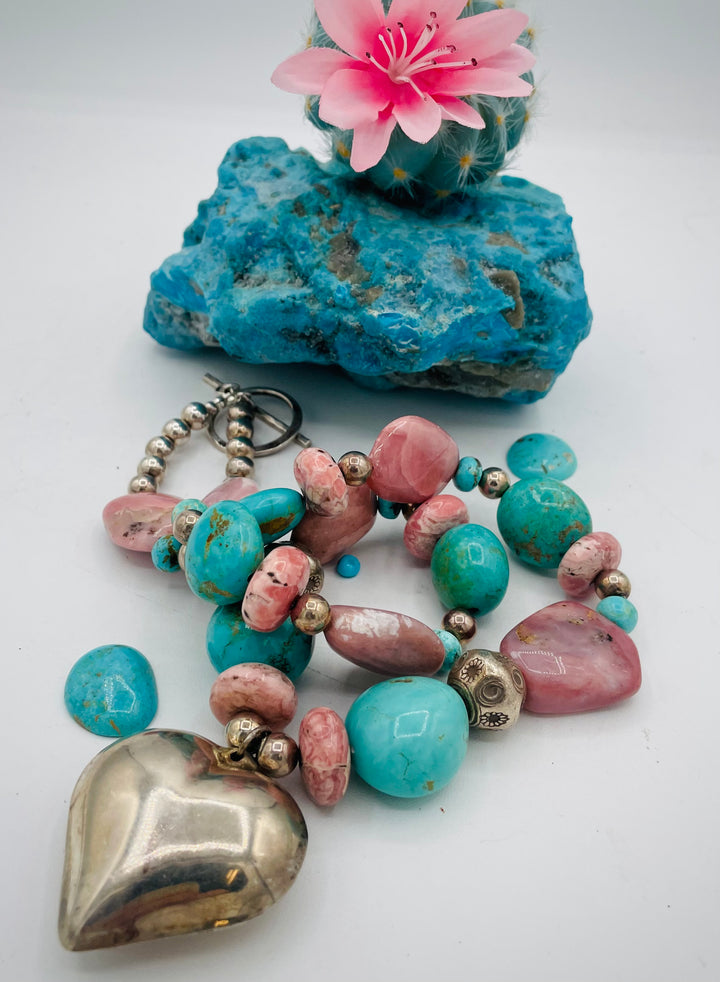 Chunky beaded necklace featuring Pink opal nuggets, rhodochrosite, sterling silver beads, Kingman turquoise nuggets, and sterling silver puffy heart pendent. Available only from Rockstar Cowgirl online or in store in Cody, Wyoming.