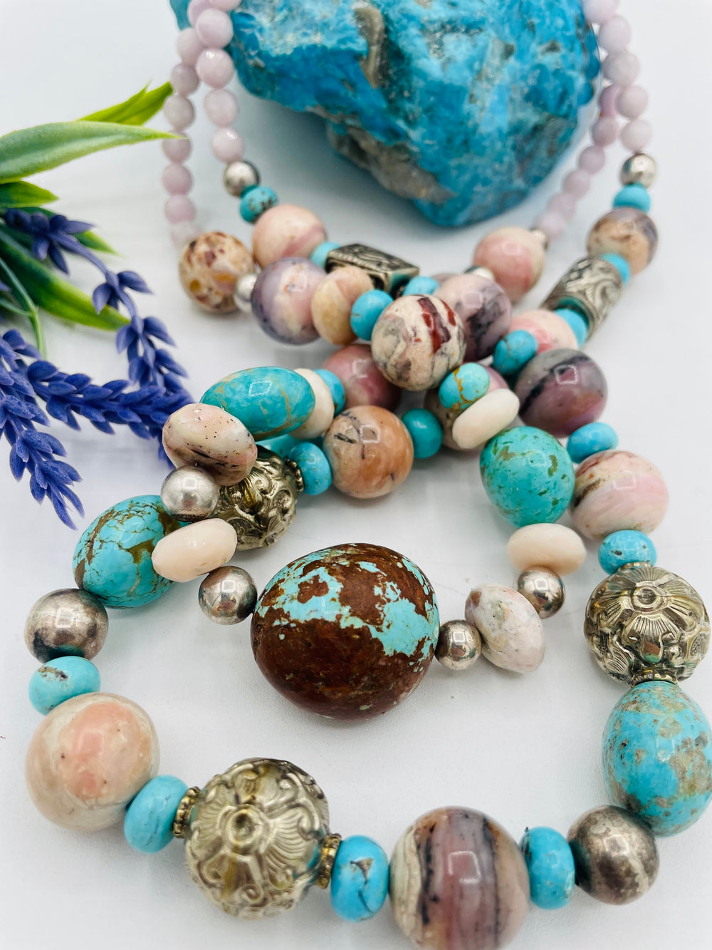 Adjustable beaded necklace featuring Pink opal, Royal beauty turquoise, Serling silver beads, Kingman turquoise, Repousse beads, pink morganite, number 8 turquoise nuggets, and finished with deer leather lace. Available only from Rockstar Cowgirl online or in store in Cody, Wyoming.