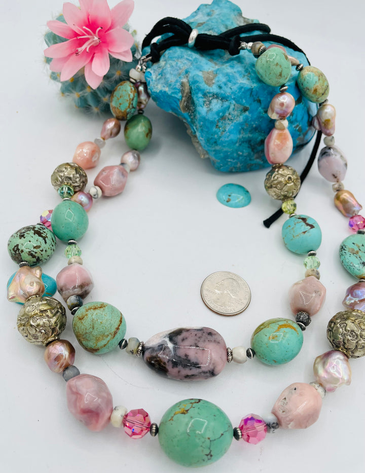 Adjustable beaded necklace featuring Kingman turquoise nuggets, pink opal, pearls, Swarovski crystals, dendrite opal, sterling silver beads, repousse beads, and finished with deer lace and slide bead. U.S. quarter for size reference. Available only from Rockstar Cowgirl online or in store in Cody, Wyoming.