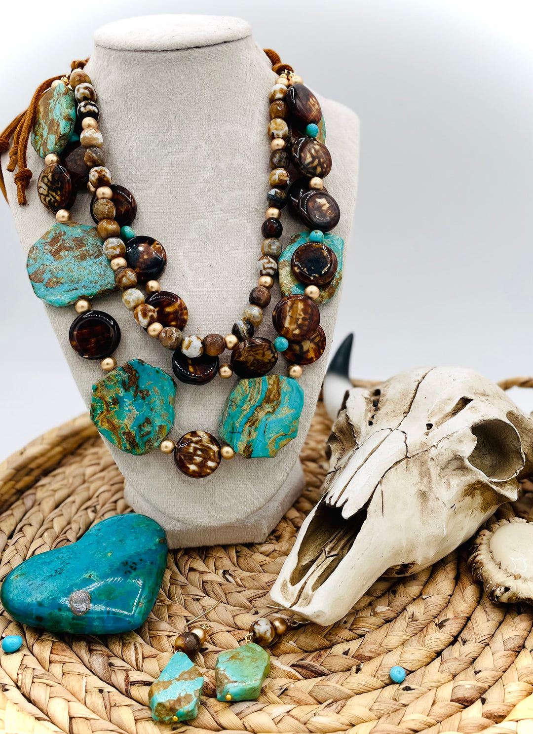 Beaded three strand necklace featuring Kingman turquoise, fire agate, gold hematite, deer lace, and slide bead. Includes matching earrings. Available only from Rockstar Cowgirl online or in store in Cody, Wyoming.