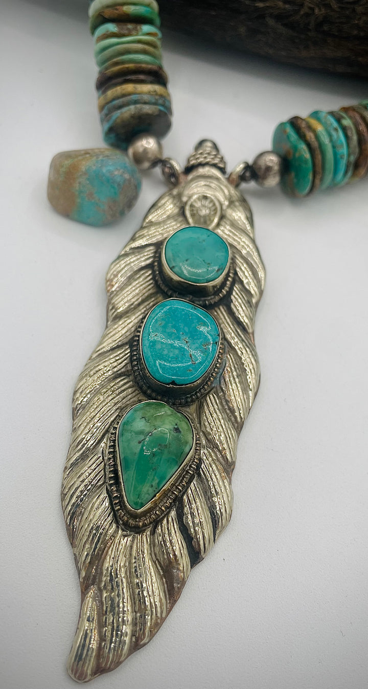 Handmade beaded necklace featuring turquoise discs, sterling silver beads, and Tibetan silver pendent with turquoise inlays. Available only from Rockstar Cowgirl online or in store in Cody, Wyoming.