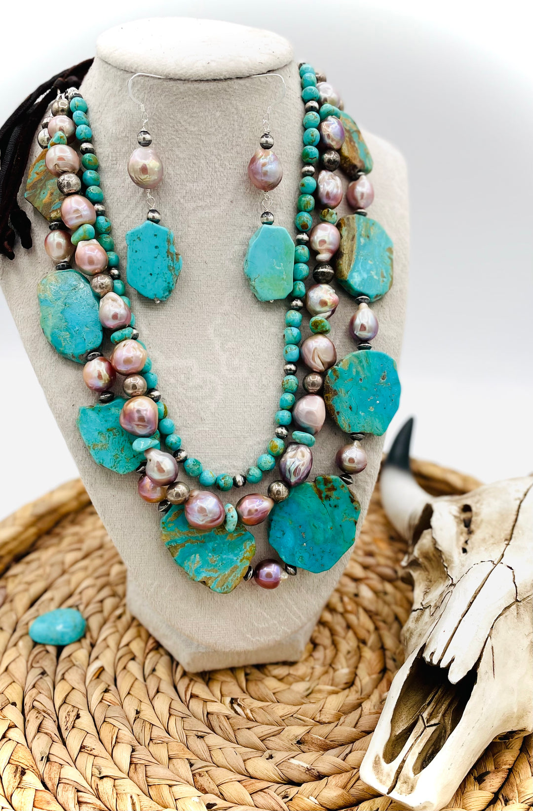 Beaded three strand necklace featuring Kingman turquoise, natural luster pearls, sterling silver beads, and finished with deer lace and slide bead. Includes matching earrings. Available only from Rockstar Cowgirl online or in store in Cody, Wyoming.