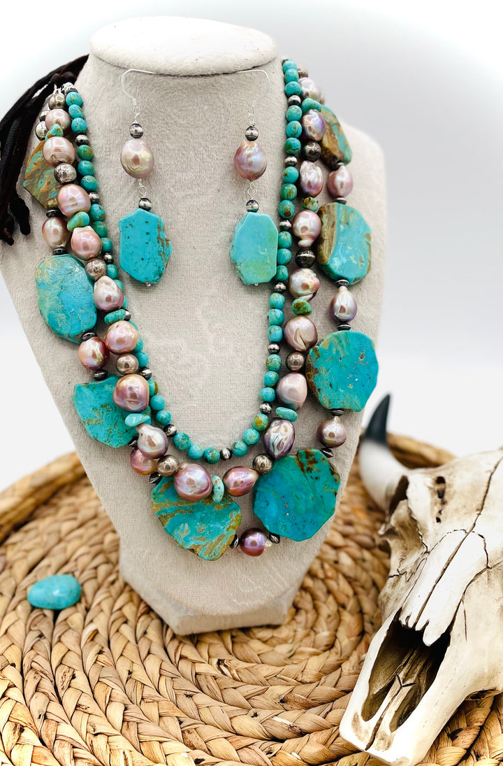 Beaded three strand necklace featuring Kingman turquoise, natural luster pearls, sterling silver beads, and finished with deer lace and slide bead. Includes matching earrings. Available only from Rockstar Cowgirl online or in store in Cody, Wyoming.