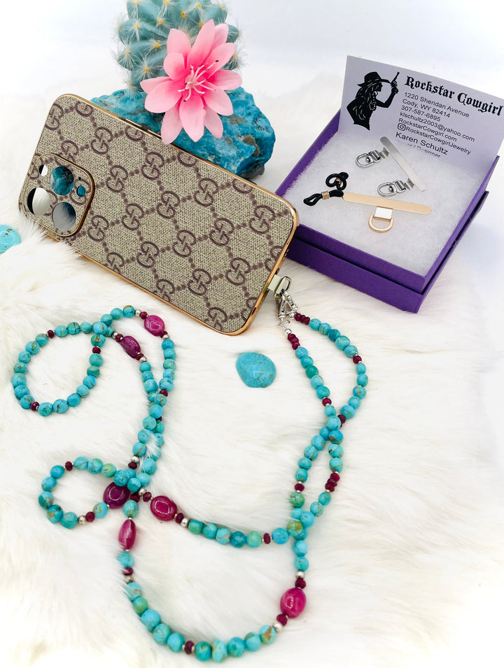 Beaded necklace, phone holder strap, or eye glass holder featuring blue Kingman turquoise, pink ruby nuggets and rondelles, sterling silver and African silver beads, sterling silver swivel lobsters, phone case attachments,  and glasses loops. Available only from Rockstar Cowgirl online or in store in Cody, Wyoming.