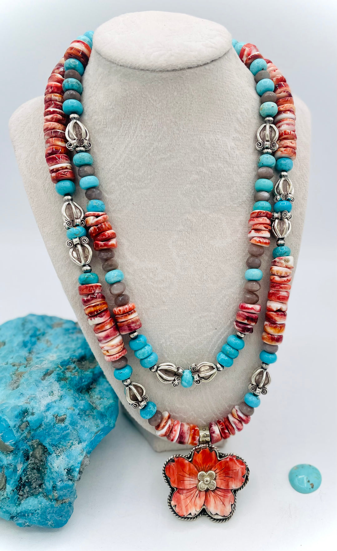 Beaded 2 strand necklace featuring spiny oyster, royal beauty turquoise, brown moonstone, and sterling silver beads with a spiny oyster flower pendent. Available only from Rockstar Cowgirl online or in store in Cody, Wyoming.