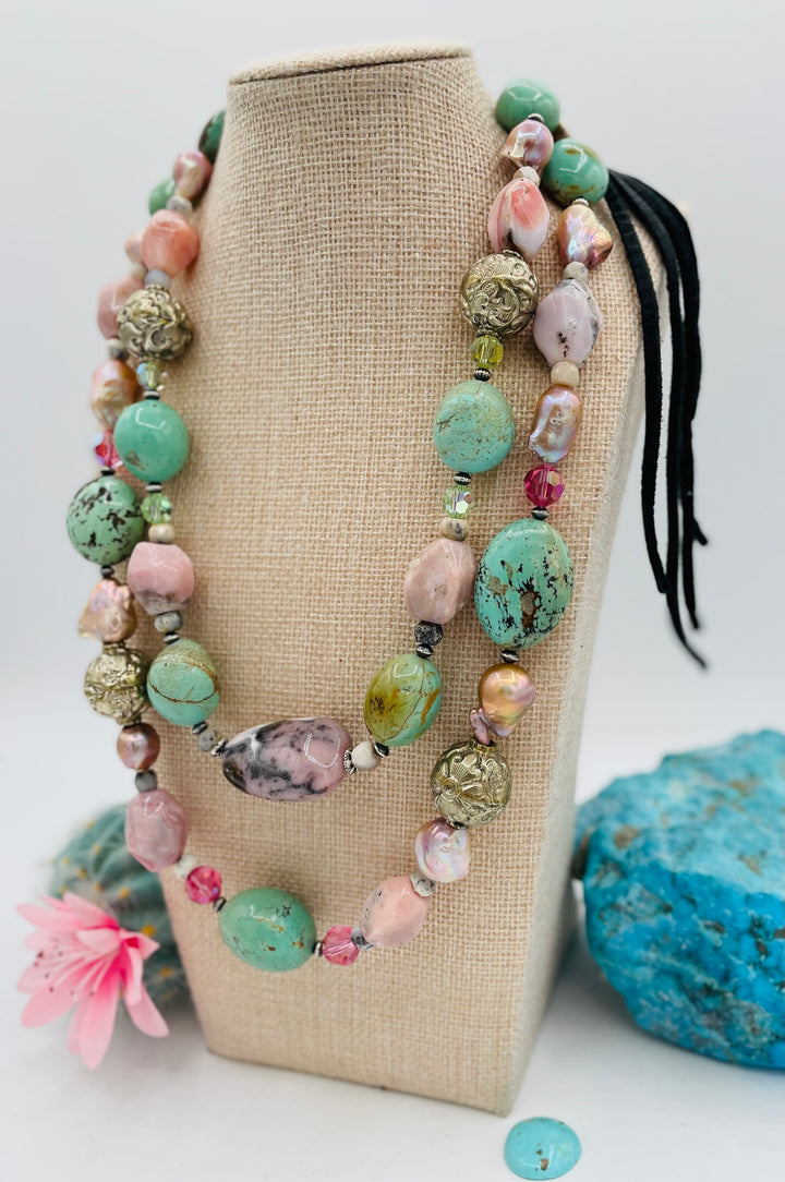 Adjustable beaded necklace featuring Kingman turquoise nuggets, pink opal, pearls, Swarovski crystals, dendrite opal, sterling silver beads, repousse beads, and finished with deer lace and slide bead. Available only from Rockstar Cowgirl online or in store in Cody, Wyoming.