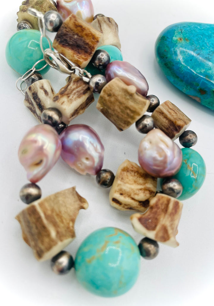 Handmade beaded necklace featuring Kingman turquoise nuggets, deer antler beads, natural luster baroque pearls, and sterling silver beads. Available only from Rockstar Cowgirl online or in store in Cody, Wyoming.