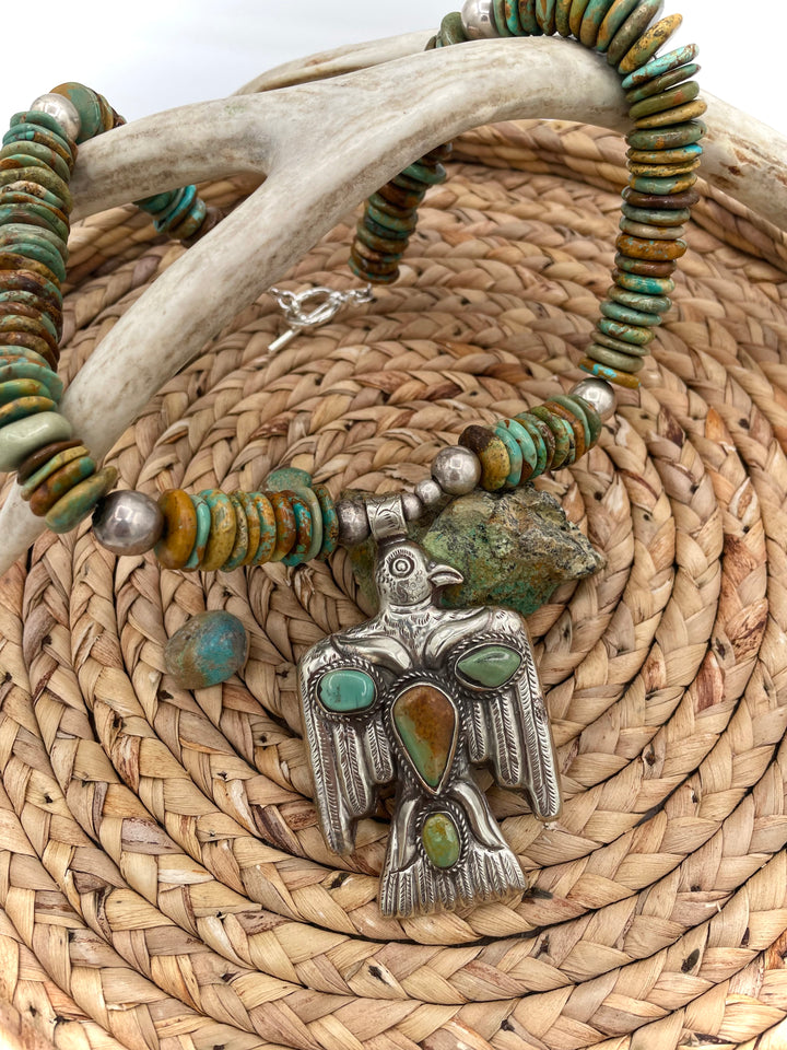 Handmade turquoise necklace featuring  turquoise discs, sterling silver accents, and Tibetan silver pendent. Available only from Rockstar Cowgirl online or in store in Cody, Wyoming.
