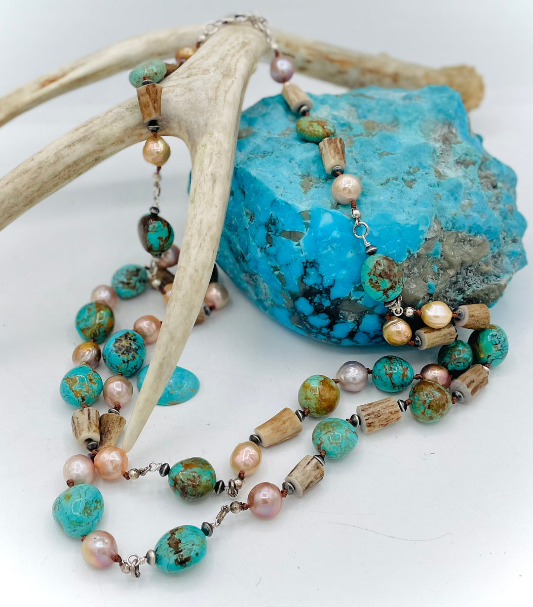 Silk knotted and wire wrapped treasure necklace with two nested strands featuring Kingman turquoise nuggets, deer antler beads, Edison natural luster pearls, and sterling silver beads. Available only from Rockstar Cowgirl online or in store in Cody, Wyoming.