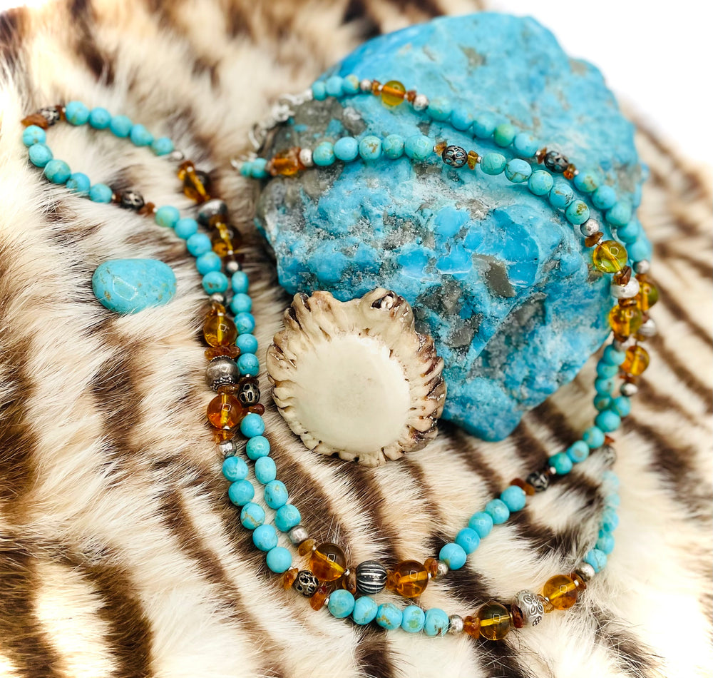 Beaded invention necklace featuring Kingman turquoise, Baltic amber, citrine, sterling silver and African silver accents with sterling silver swivel lobsters, eye glasses loops, cell phone case attachment bracket. Available only from Rockstar Cowgirl online or in store in Cody, Wyoming.