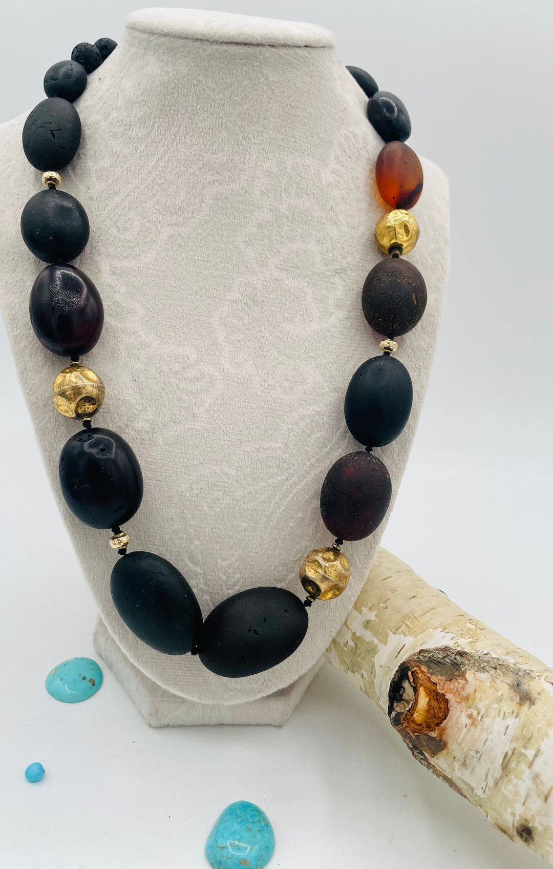 Silk knotted necklace featuring black Baltic amber nuggets, lava, and 14K gold beads. Available only from Rockstar Cowgirl online or in store in Cody, Wyoming.