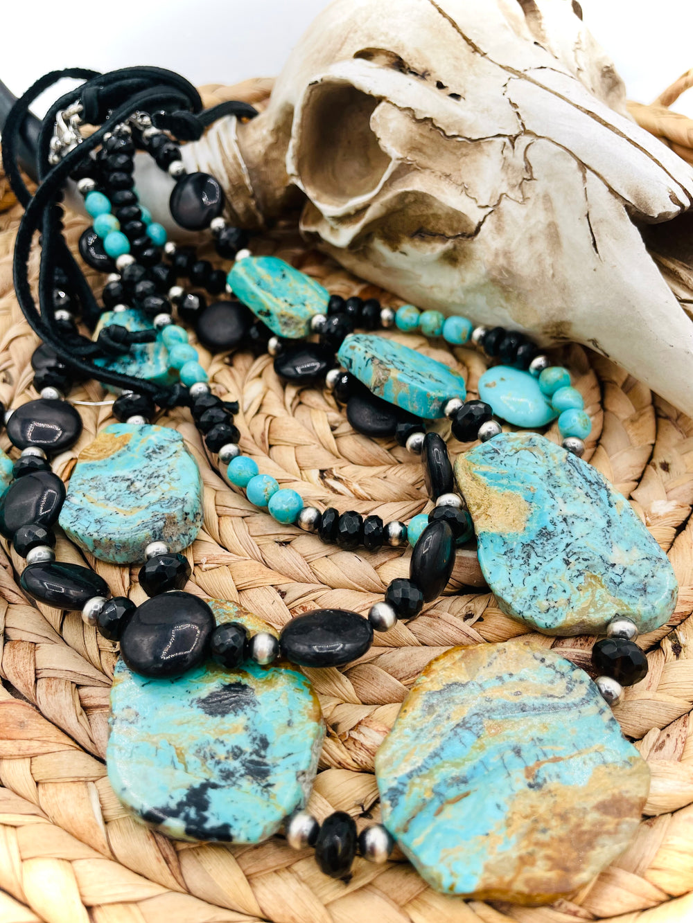 Beaded three strand necklace featuring Kingman turquoise, onyx, spinel, sterling silver, and finished with deer lace and slide bead. Includes matching earrings. Available only from Rockstar Cowgirl online or in store in Cody, Wyoming.