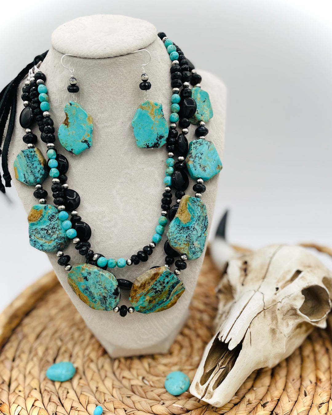 Beaded three strand necklace featuring Kingman turquoise, onyx, spinel, sterling silver, and finished with deer lace and slide bead. Includes matching earrings. Available only from Rockstar Cowgirl online or in store in Cody, Wyoming.