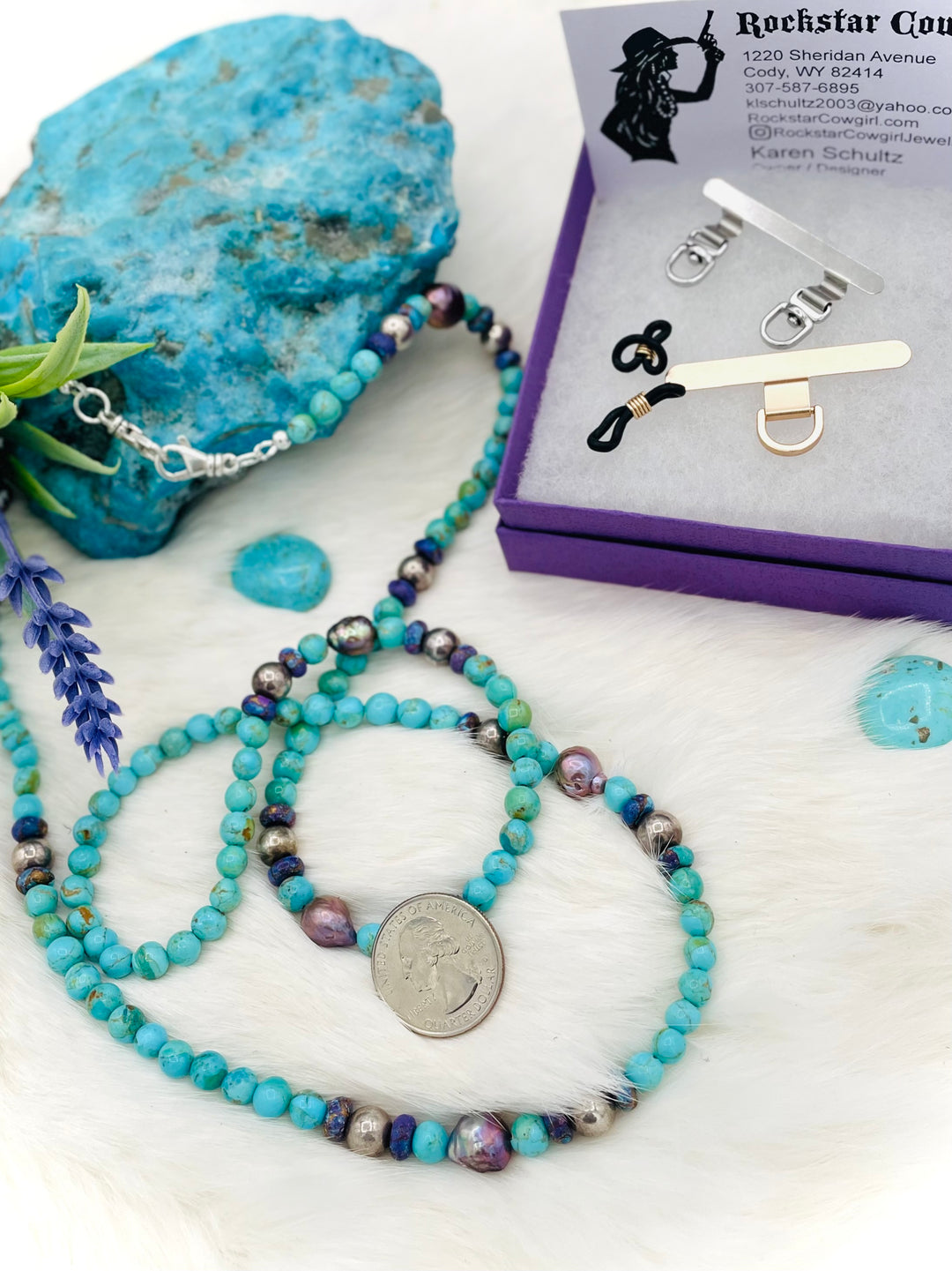 Beaded invention necklace featuring Kingman turquoise, Mojave Mohave turquoise, peacock pearls, sterling silver beads, and sterling silver swivel lobsters, with eye glasses loops and cell phone case attachment brackets. U.S. quarter for size reference. Available only from Rockstar Cowgirl online or in store in Cody, Wyoming.