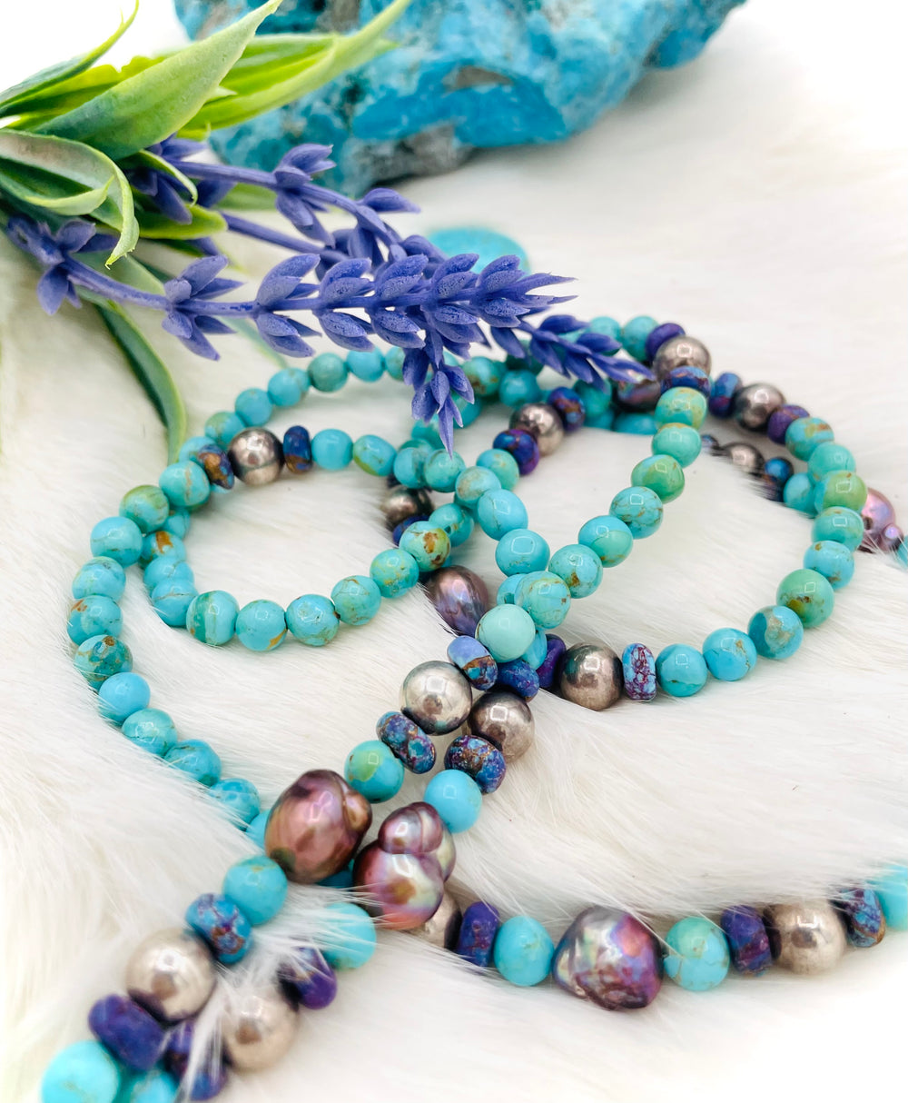 Beaded invention necklace featuring Kingman turquoise, Mojave Mohave turquoise, peacock pearls, sterling silver beads, and sterling silver swivel lobsters, with eye glasses loops and cell phone case attachment brackets. Available only from Rockstar Cowgirl online or in store in Cody, Wyoming.