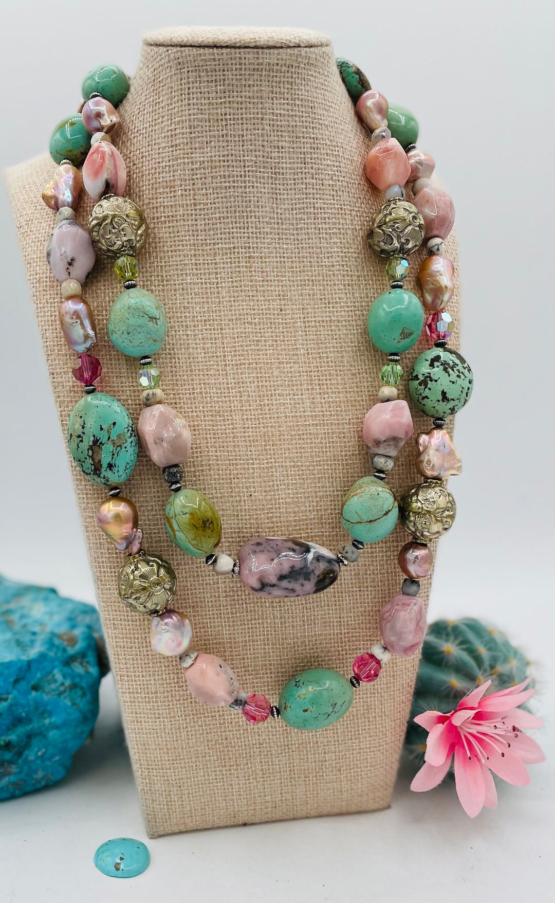 Adjustable beaded necklace featuring Kingman turquoise nuggets, pink opal, pearls, Swarovski crystals, dendrite opal, sterling silver beads, repousse beads, and finished with deer lace and slide bead. Available only from Rockstar Cowgirl online or in store in Cody, Wyoming.