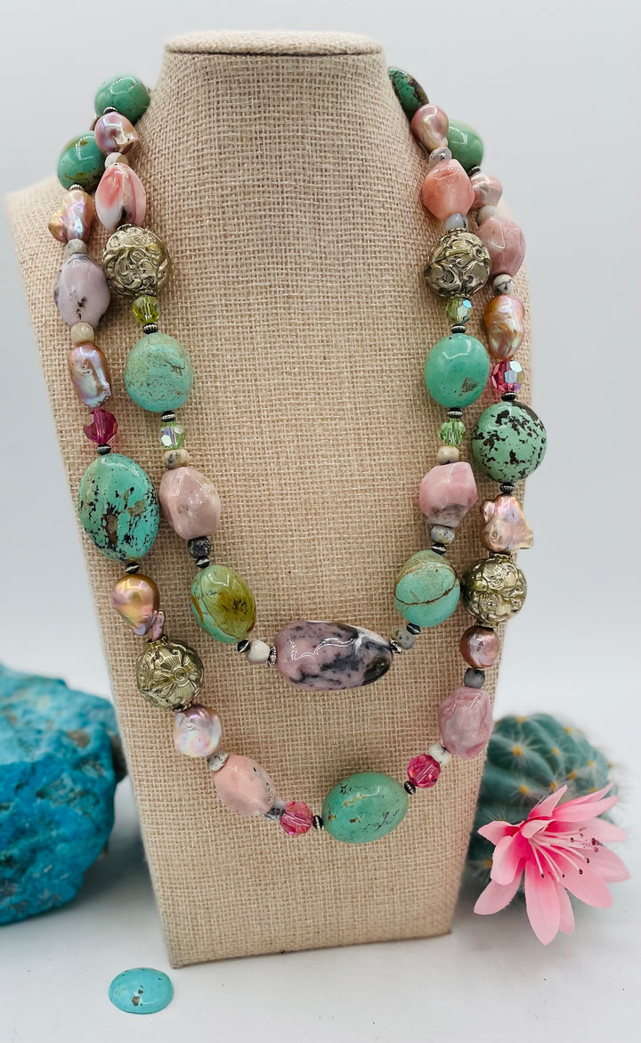 Adjustable beaded necklace featuring Kingman turquoise nuggets, pink opal, pearls, Swarovski crystals, dendrite opal, sterling silver beads, repousse beads, and finished with deer lace and slide bead. Available only from Rockstar Cowgirl online or in store in Cody, Wyoming.