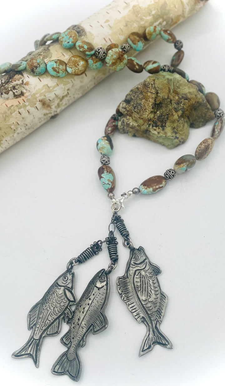 Beaded necklace featuring vintage #8 turquoise nuggets, sterling silver beads, and handmade sterling silver signed fish charms. Marcie. Available only from Rockstar Cowgirl online or in store in Cody, Wyoming.