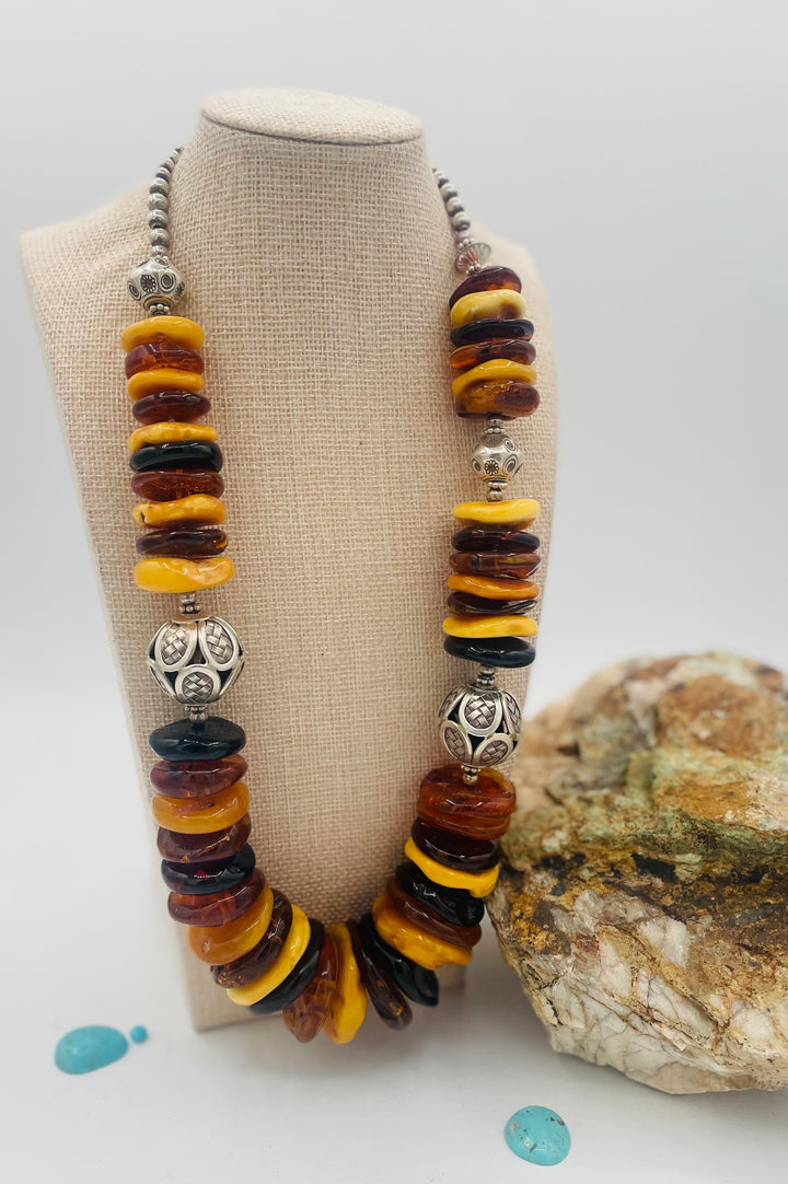 Beaded necklace featuring multi colored Baltic amber discs an handmade sterling silver beads. Available only from Rockstar Cowgirl online or in store in Cody, Wyoming.
