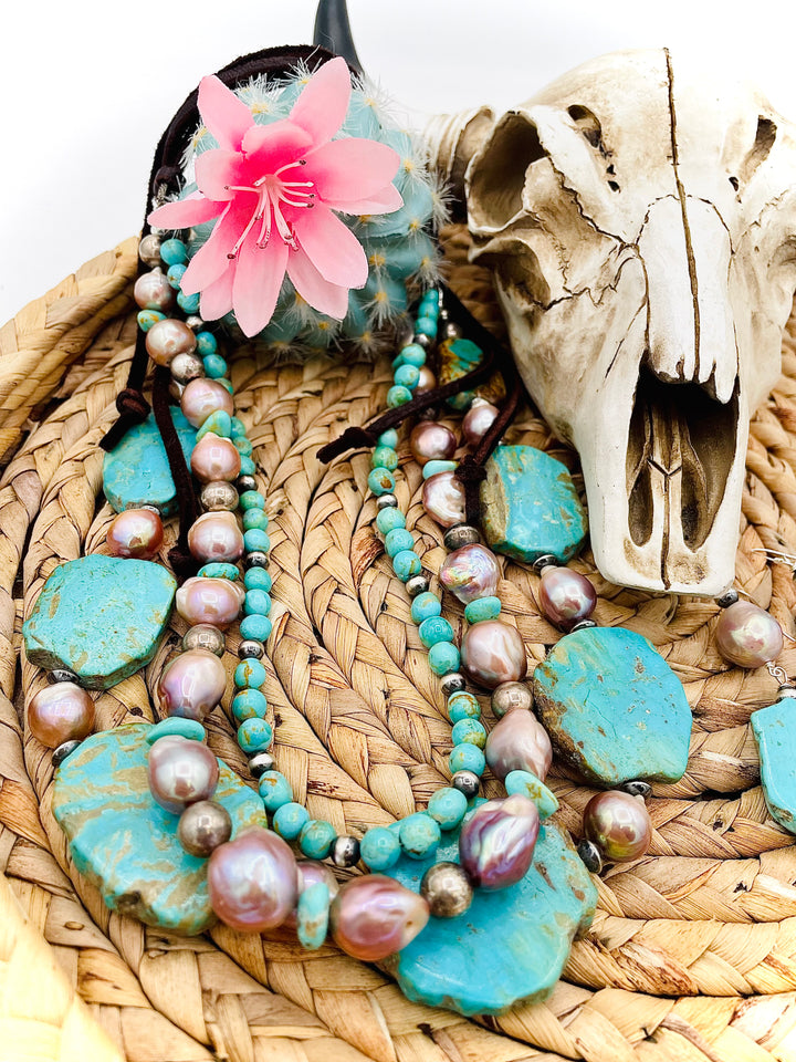 Beaded three strand necklace featuring Kingman turquoise, natural luster pearls, sterling silver beads, and finished with deer lace and slide bead. Includes matching earrings. Available only from Rockstar Cowgirl online or in store in Cody, Wyoming.