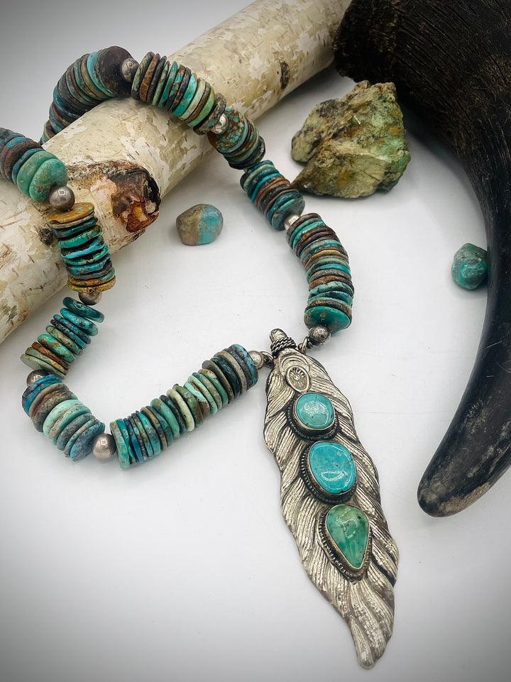 Handmade beaded necklace featuring turquoise discs, sterling silver beads, and Tibetan silver pendent with turquoise inlays. Available only from Rockstar Cowgirl online or in store in Cody, Wyoming.