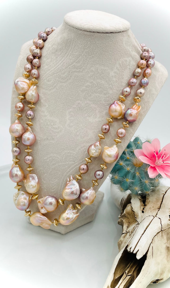 Silk knotted 2 strand necklace featuring flame ball natural luster pearls, smaller pink pearls, 14k gold accents, and finished a small turquoise heart at the back. Available only from Rockstar Cowgirl online or in store in Cody, Wyoming.