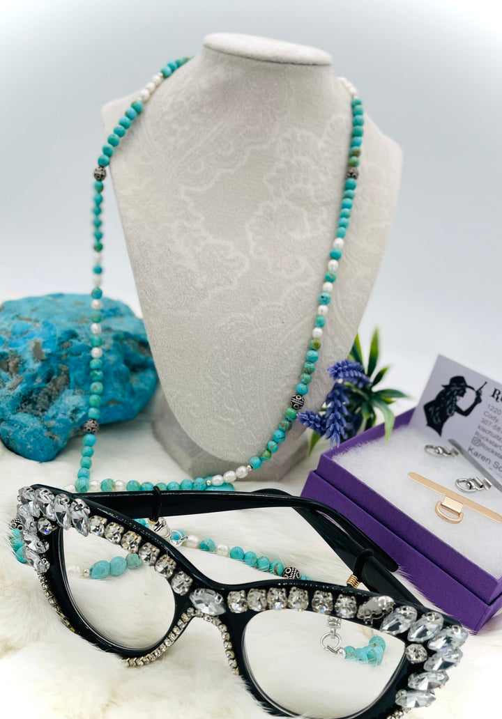 Beaded invention necklace featuring Kingman turquoise, freshwater pearls, sterling sliver accent beads, with sterling silver swivel lobsters, eye glasses loops, and cell phone case attachment bracket. Available only from Rockstar Cowgirl online or in store in Cody, Wyoming. 