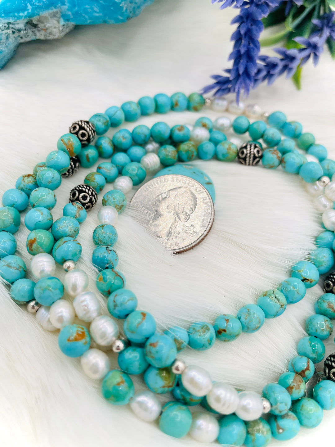 Beaded invention necklace featuring Kingman turquoise, freshwater pearls, sterling sliver accent beads, with sterling silver swivel lobsters, eye glasses loops, and cell phone case attachment bracket. U.S. quarter for size reference. Available only from Rockstar Cowgirl online or in store in Cody, Wyoming. 