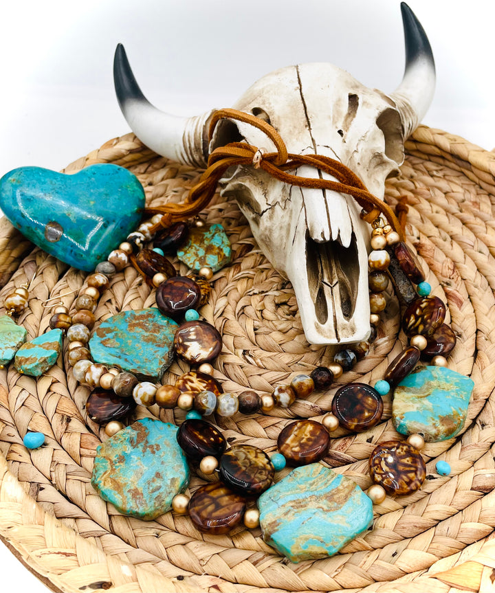Beaded three strand necklace featuring Kingman turquoise, fire agate, gold hematite, deer lace, and slide bead. Includes matching earrings. Available only from Rockstar Cowgirl online or in store in Cody, Wyoming.